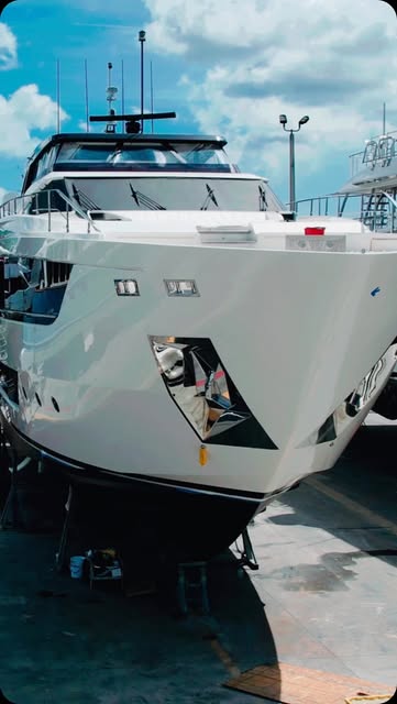 Freshly detailed white motor yacht bow in a Fort Lauderdale yard