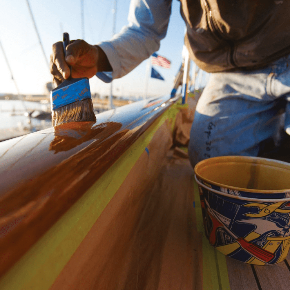 Yacht brightwork being varnished by a Global Yacht Detailing craftsman