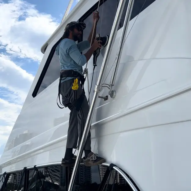Global Yacht Detailing technician detailing a motor yacht exterior